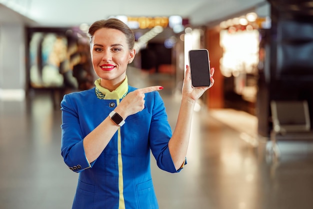 A traveler excitedly pointing at a flight booking confirmation on their smartphone, highlighting a 20% discount. They are sitting in a cozy cafe with a world map in the background, symbolizing the joy of securing a great deal for their upcoming international trip.